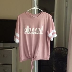 “Blessed” blush/pink shirt.